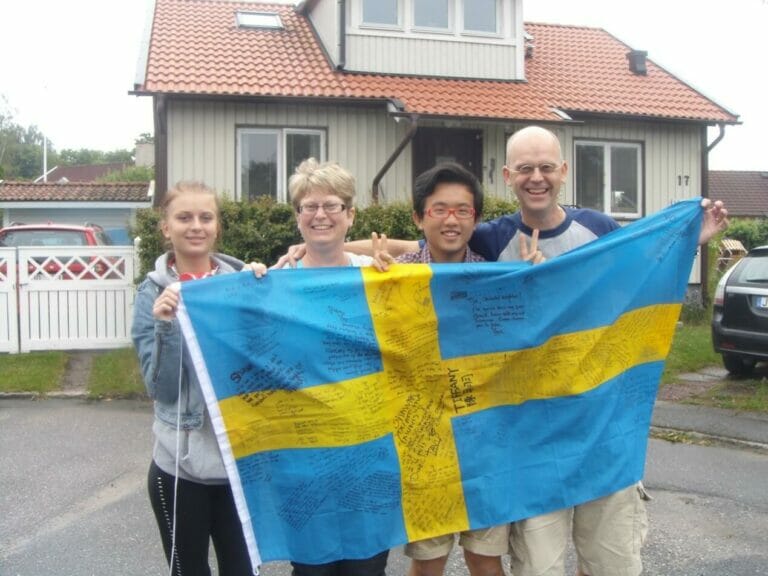My awesome host family and I stood in front of their house, holding a giant Swedish flag.
